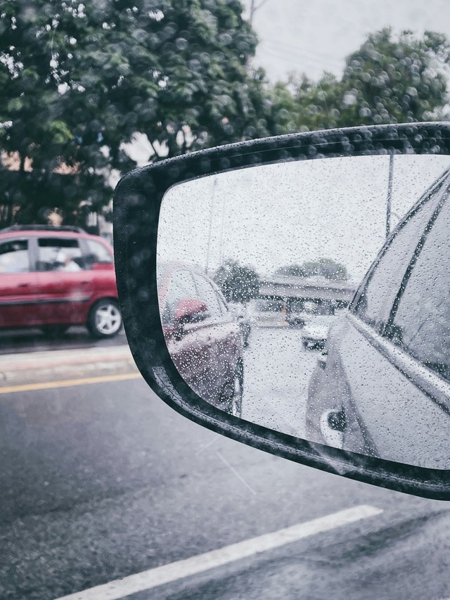 Espejo retrovisor con lluvia en carretera de Guayaquil