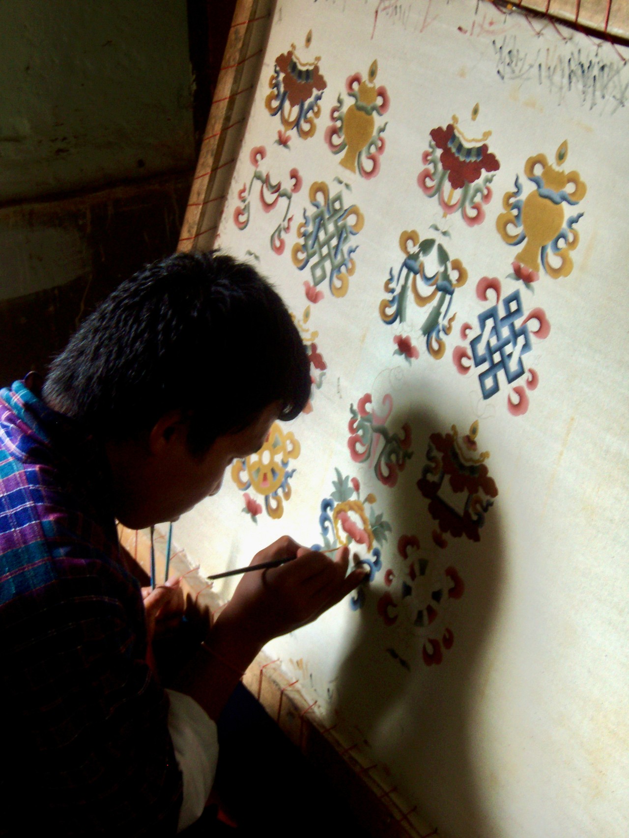 Artesano ecuatoriano pintando diseños tradicionales